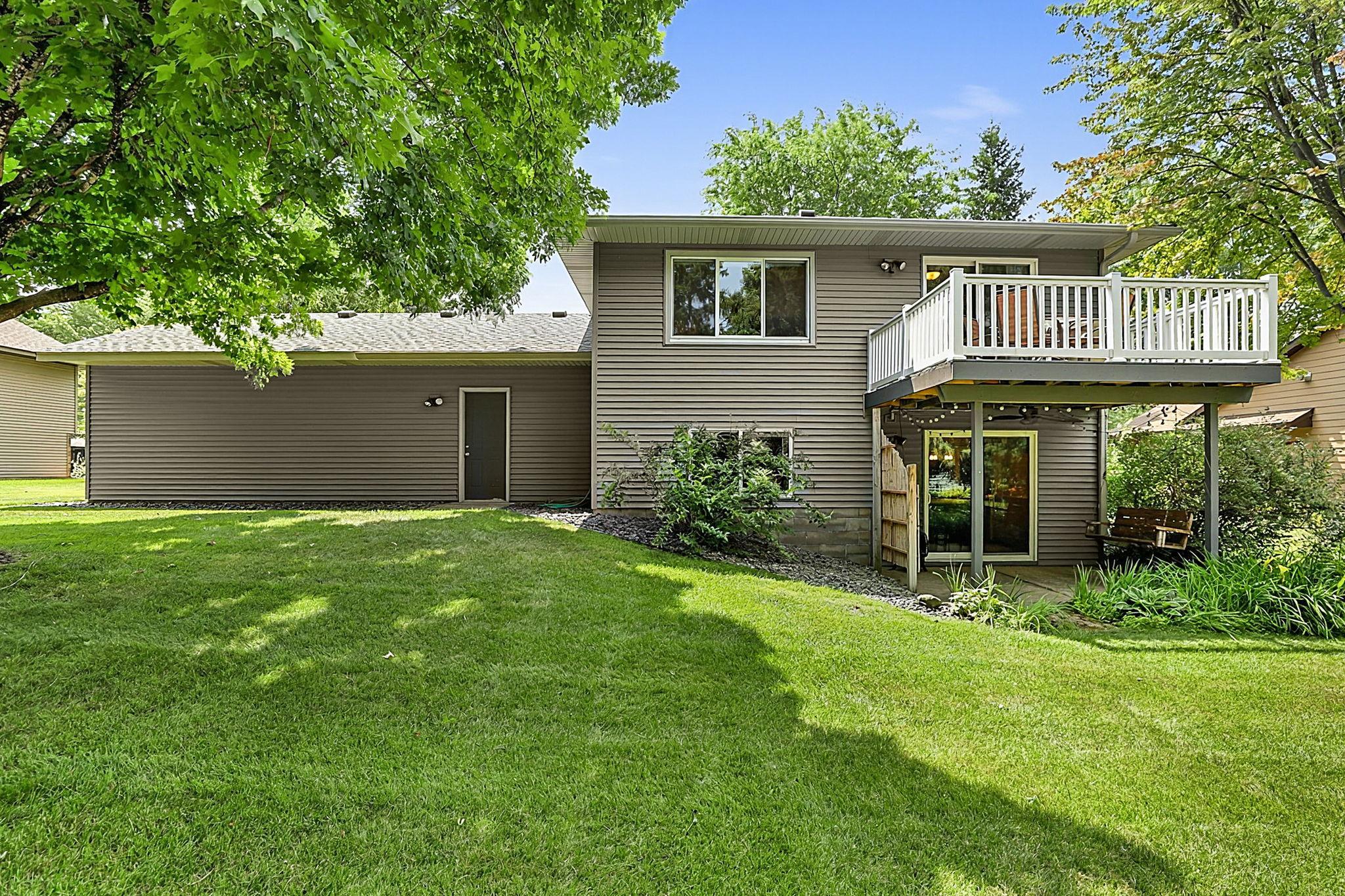 A look at the back of the home featuring the deck and convenient walkout access to the patio and backyard.