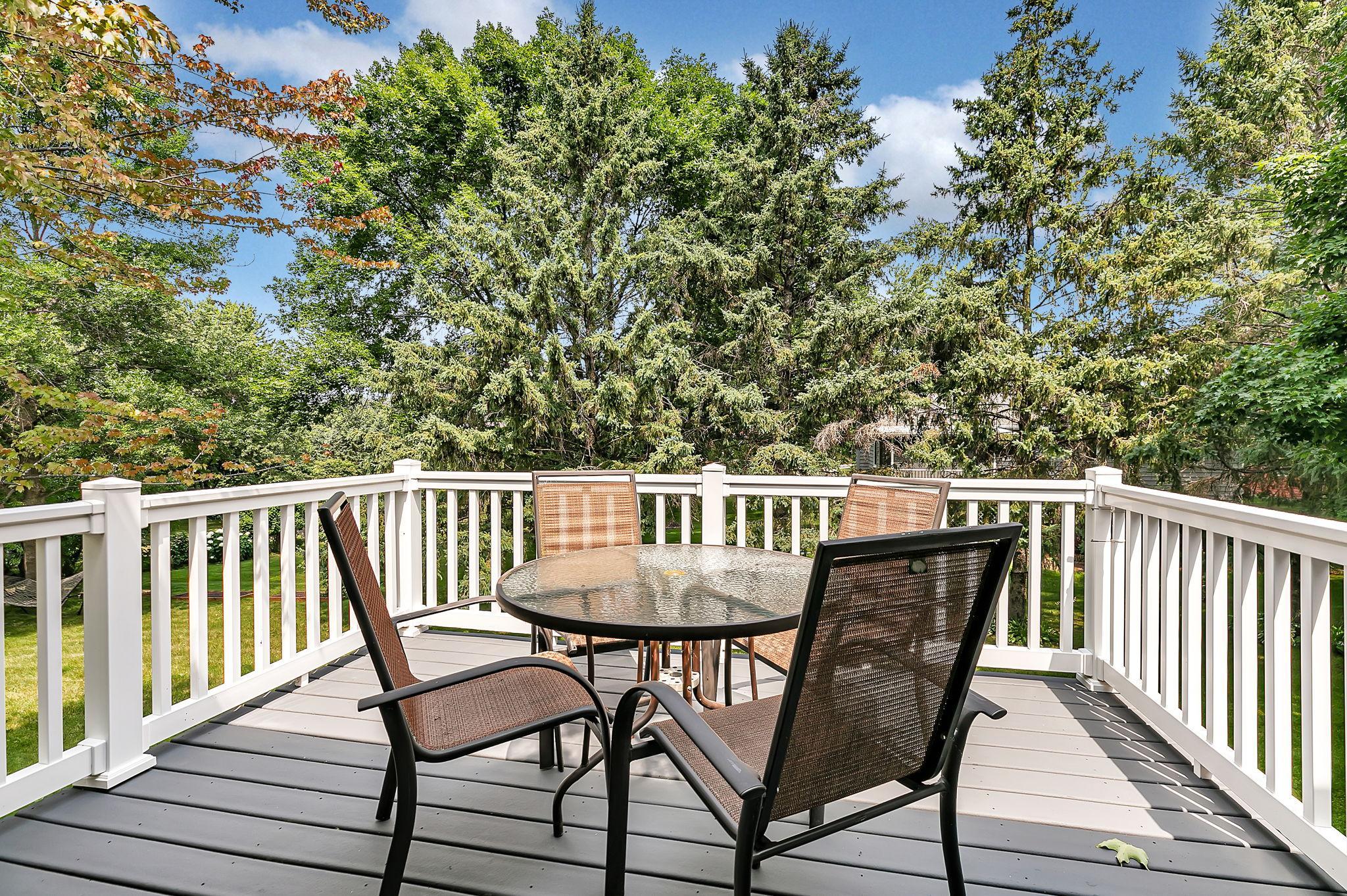 The deck, located just off the dining room, overlooks the mature trees in the backyard and is built with low-maintenance materials for easy outdoor enjoyment.