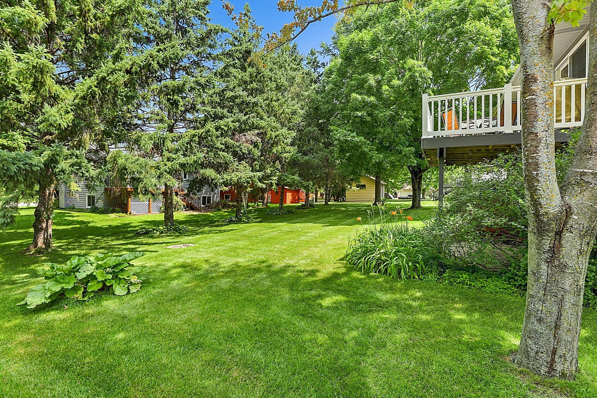 Private, peaceful, and surrounded by mature trees. The deck and walkout patio make it easy to enjoy every season in this beautiful backyard.