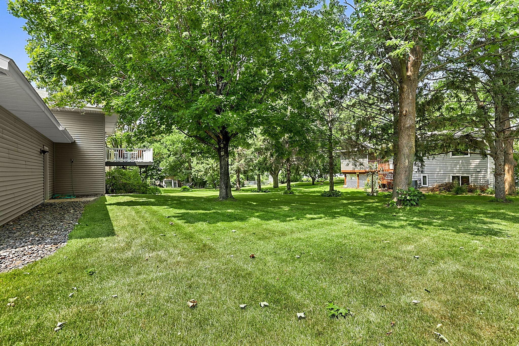 A beautifully maintained yard with mature trees creates a backyard space you’ll love spending time in.