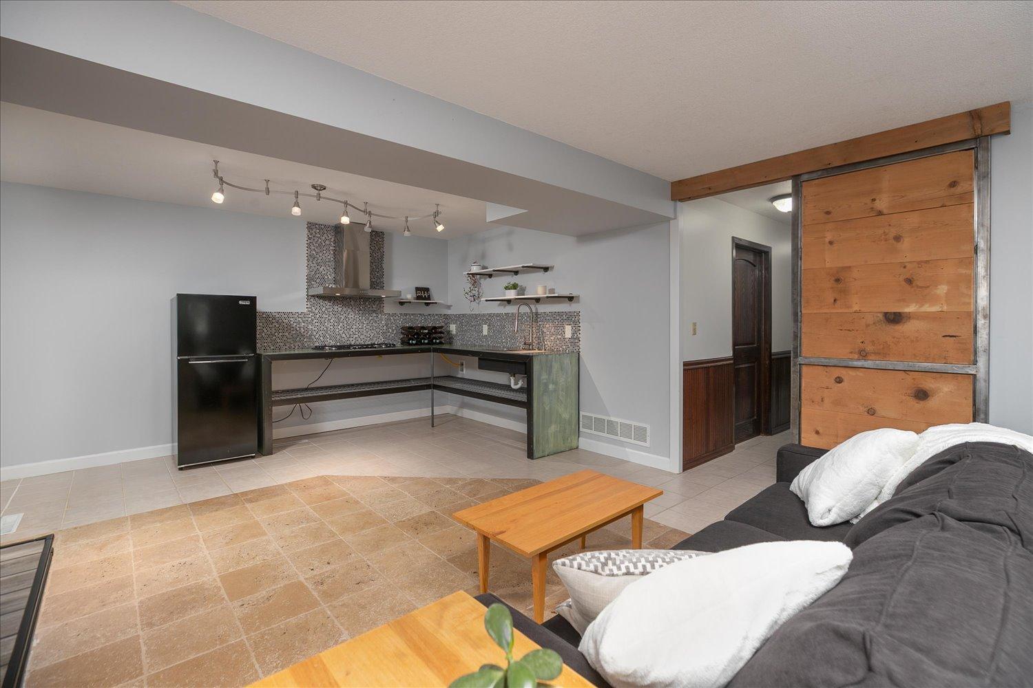 Lower level family room featuring 1/2 kitchen