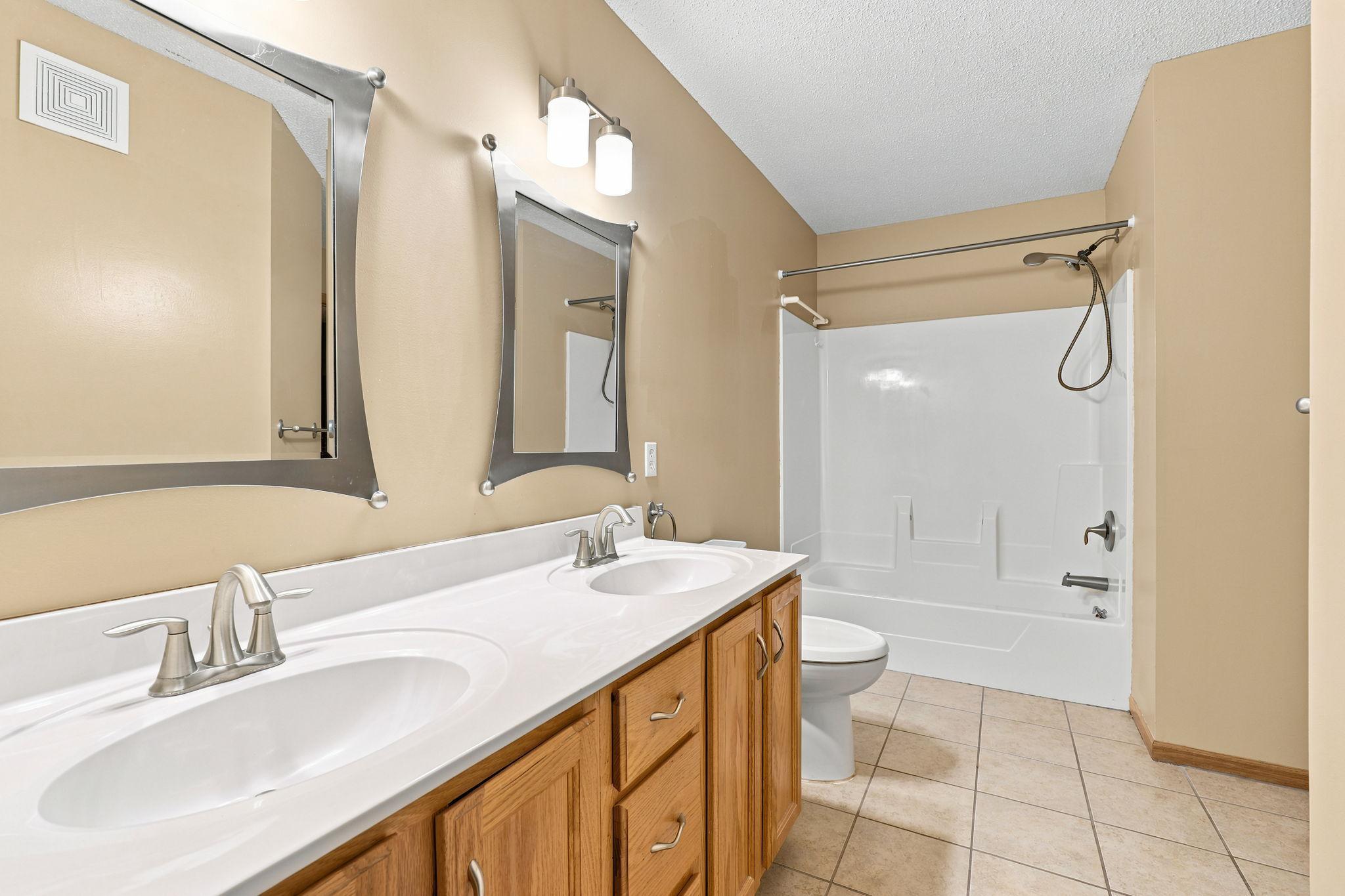 Ensuite full bath with double vanity sink