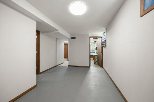 Lower level family room area with door leading to the utility room