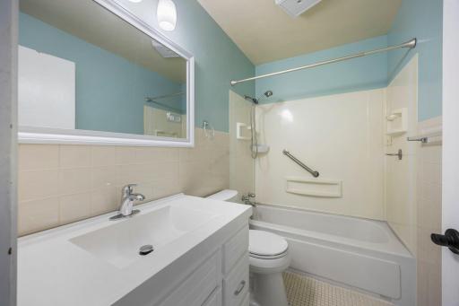 Main level full sized tiled bathroom located between the two bedrooms and right off the hall from the dining area
