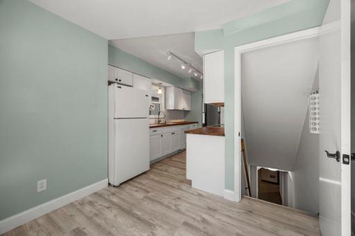 Stairwell off the kitchen leads to the lower level family room and laundry area.