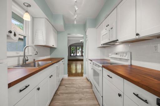 Updated kitchen with large sink, dishwasher and ample counter space