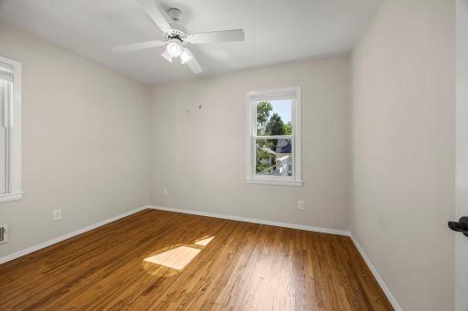 Main level second bedroom with view of backyard and deck area