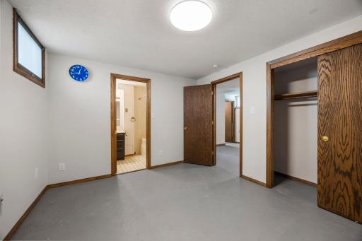 Lower level room with attached full bathroom, and large sliding door closet right off from the family room area