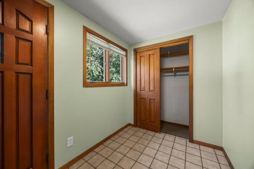 Tiled front entryway with sliding door coat closet