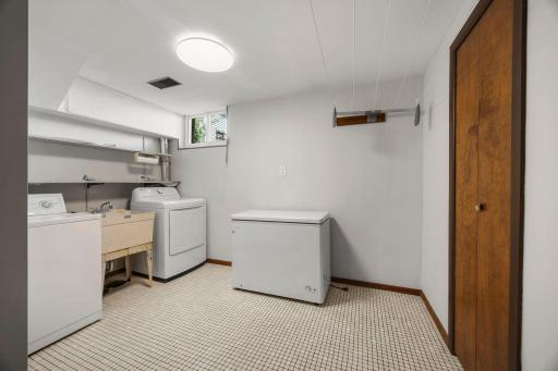 Lower level laundry with shelving and storage space