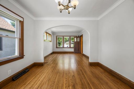 Family room with lovely archway entry leading to the dining area