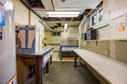 Lower level utility room with lots of extra storage space and workbench area