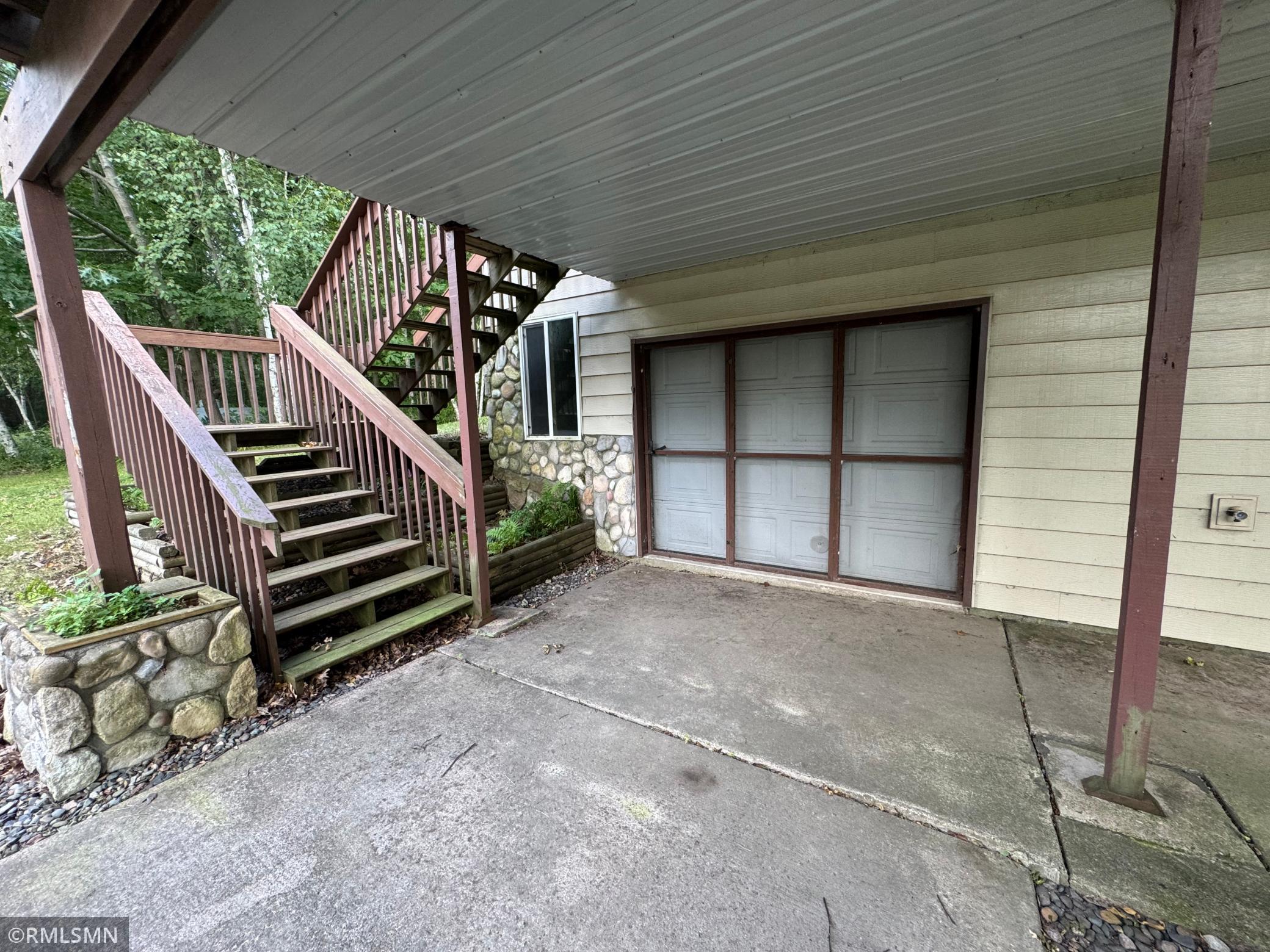 Tunk Under Garage has screen door for versatile space.