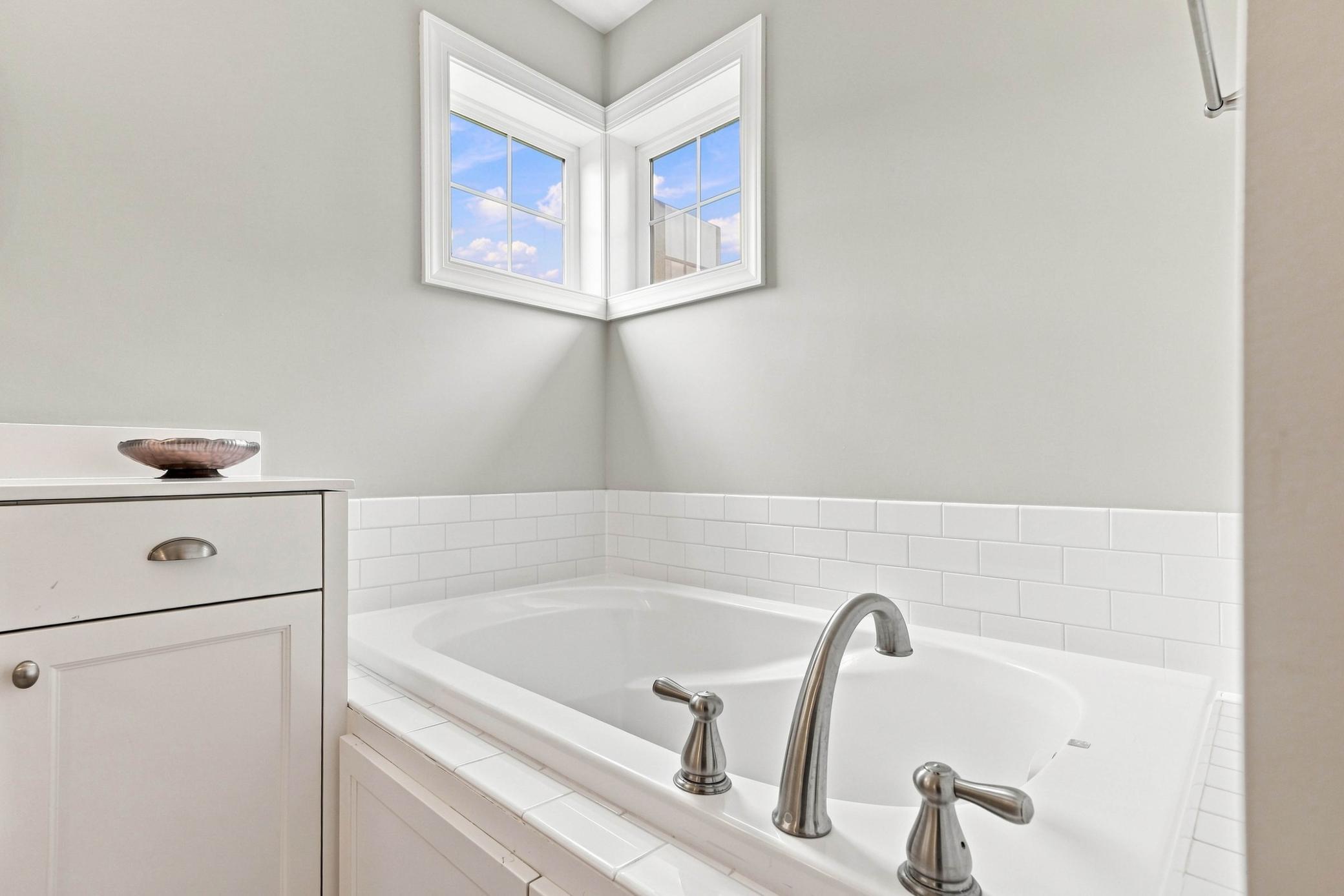Separate soaking tub and walk-in shower create a luxurious experience.