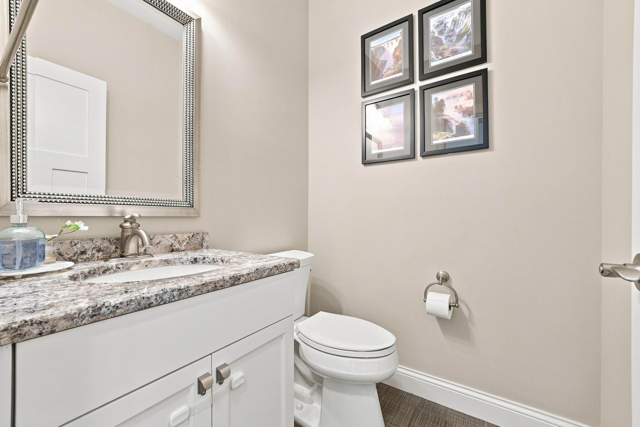 Main-level powder room with timeless finishes.