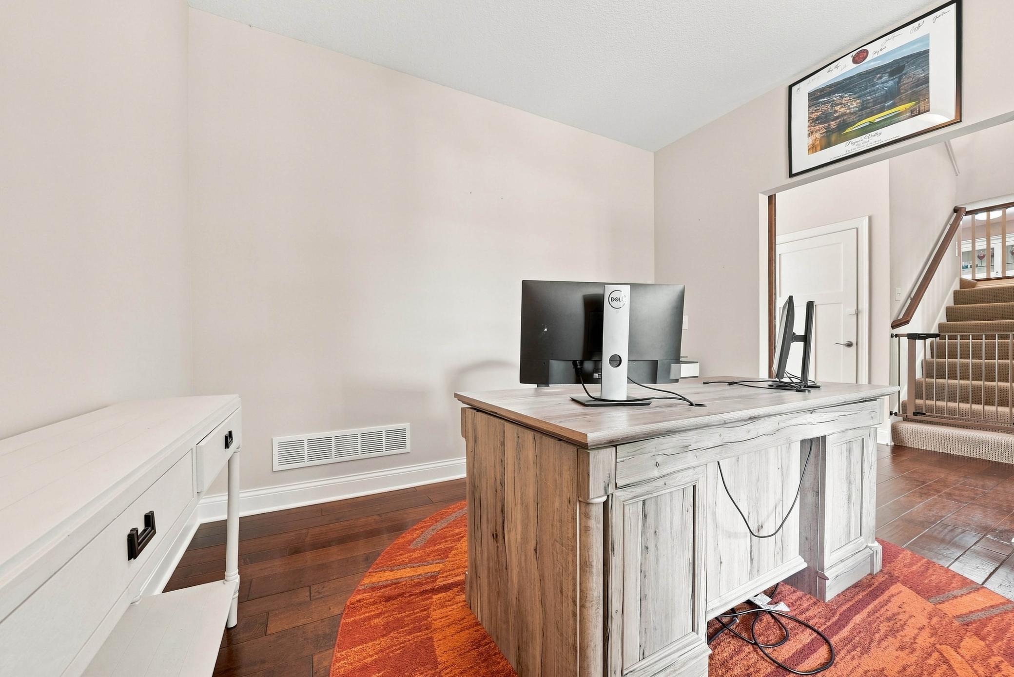 Main-floor office with barn doors for work-from-home flexibility.