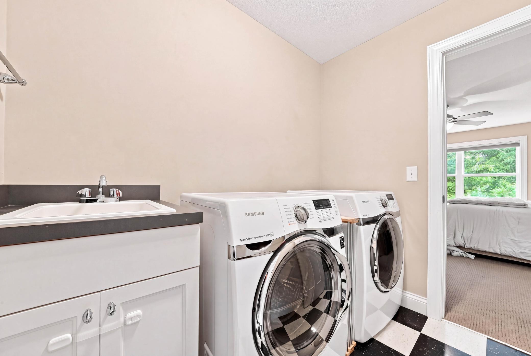 Convenient upper-level laundry with direct access from the primary suite.