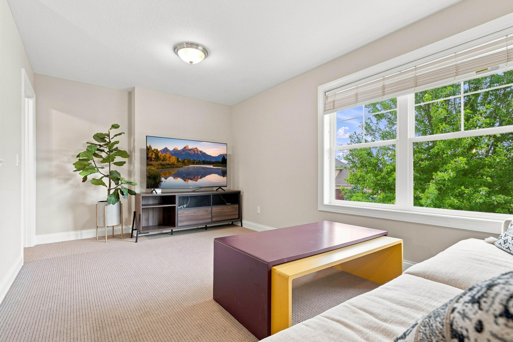 Versatile upper-level loft for a home office, lounge, or playroom.