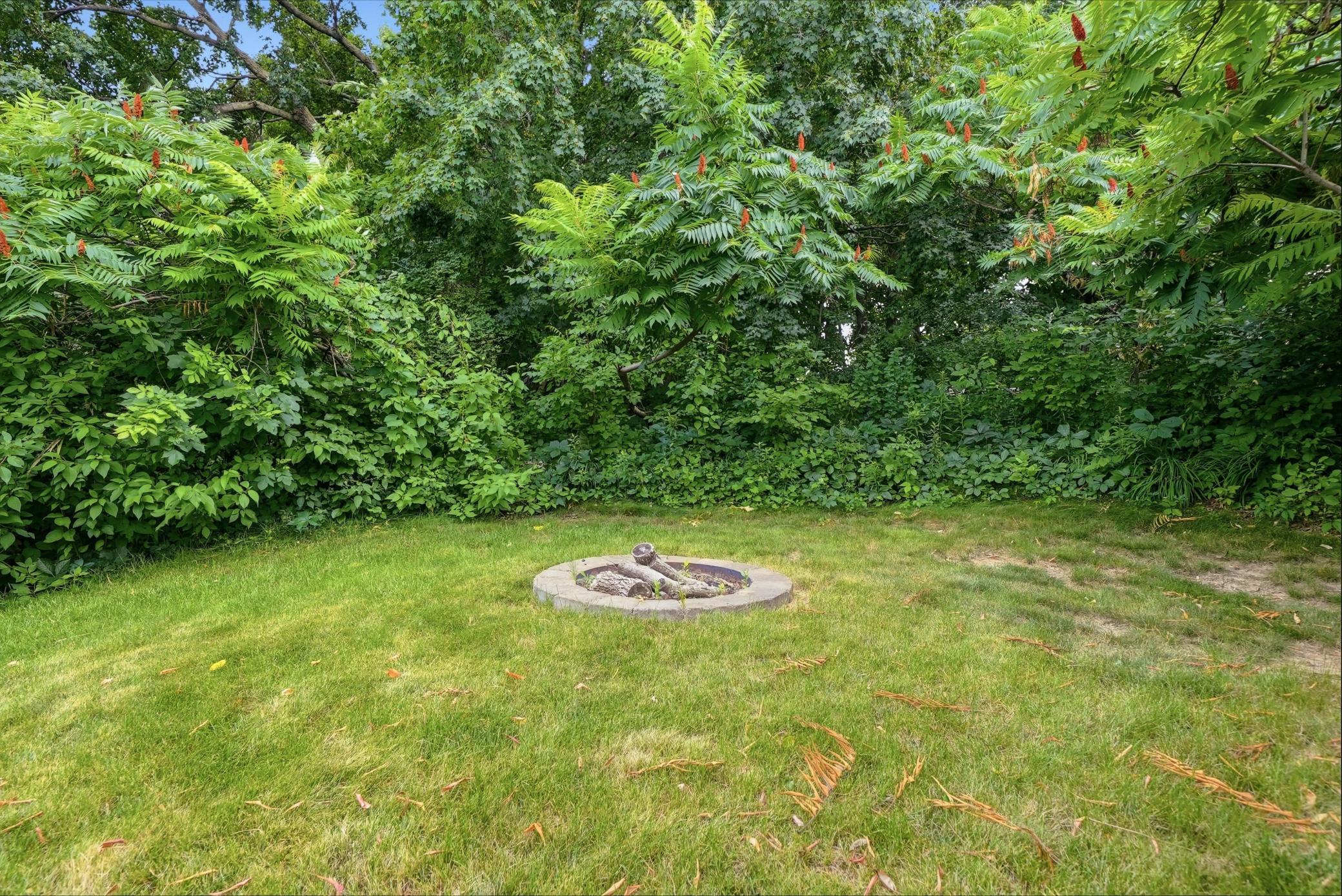 A private backyard surrounded by mature trees.