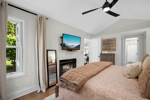 Main floor primary bedroom with see through fireplace