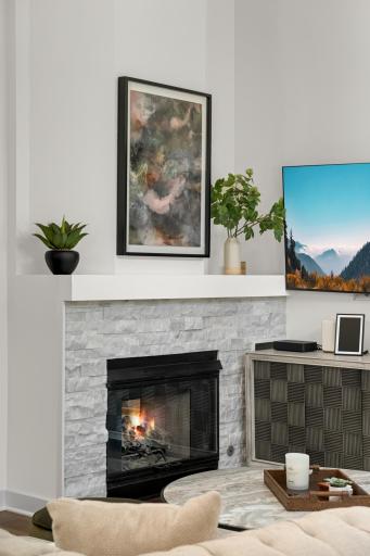 Stacked stone gas fireplace and enameled mantle