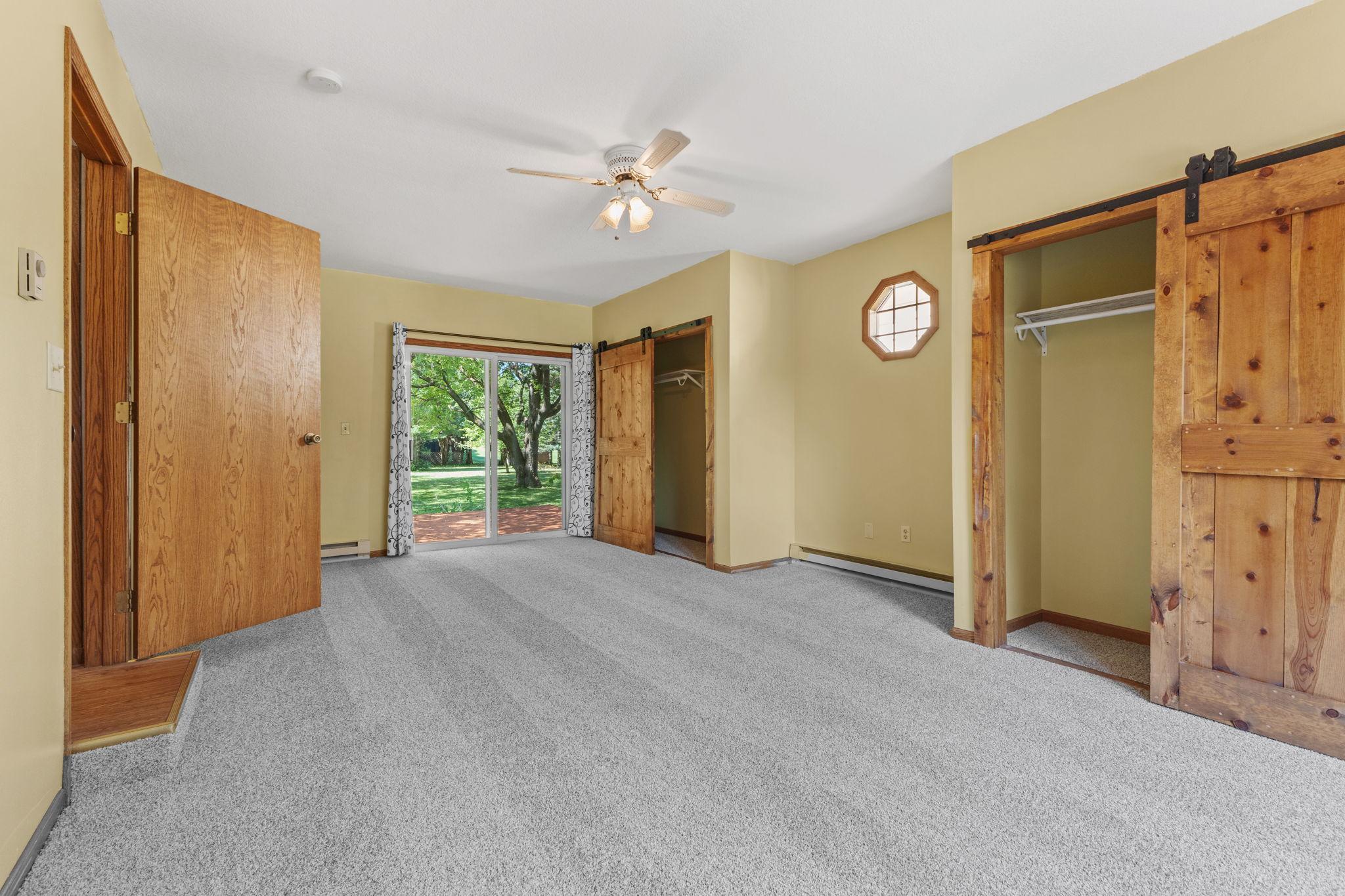 Primary bedroom with walkout doors to deck