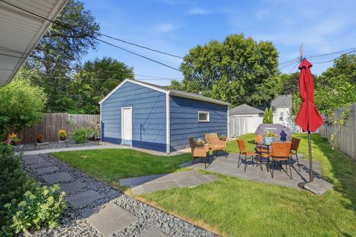 Beautifully landscaped backyard and 2 car garage with a floor you could serve dinner from