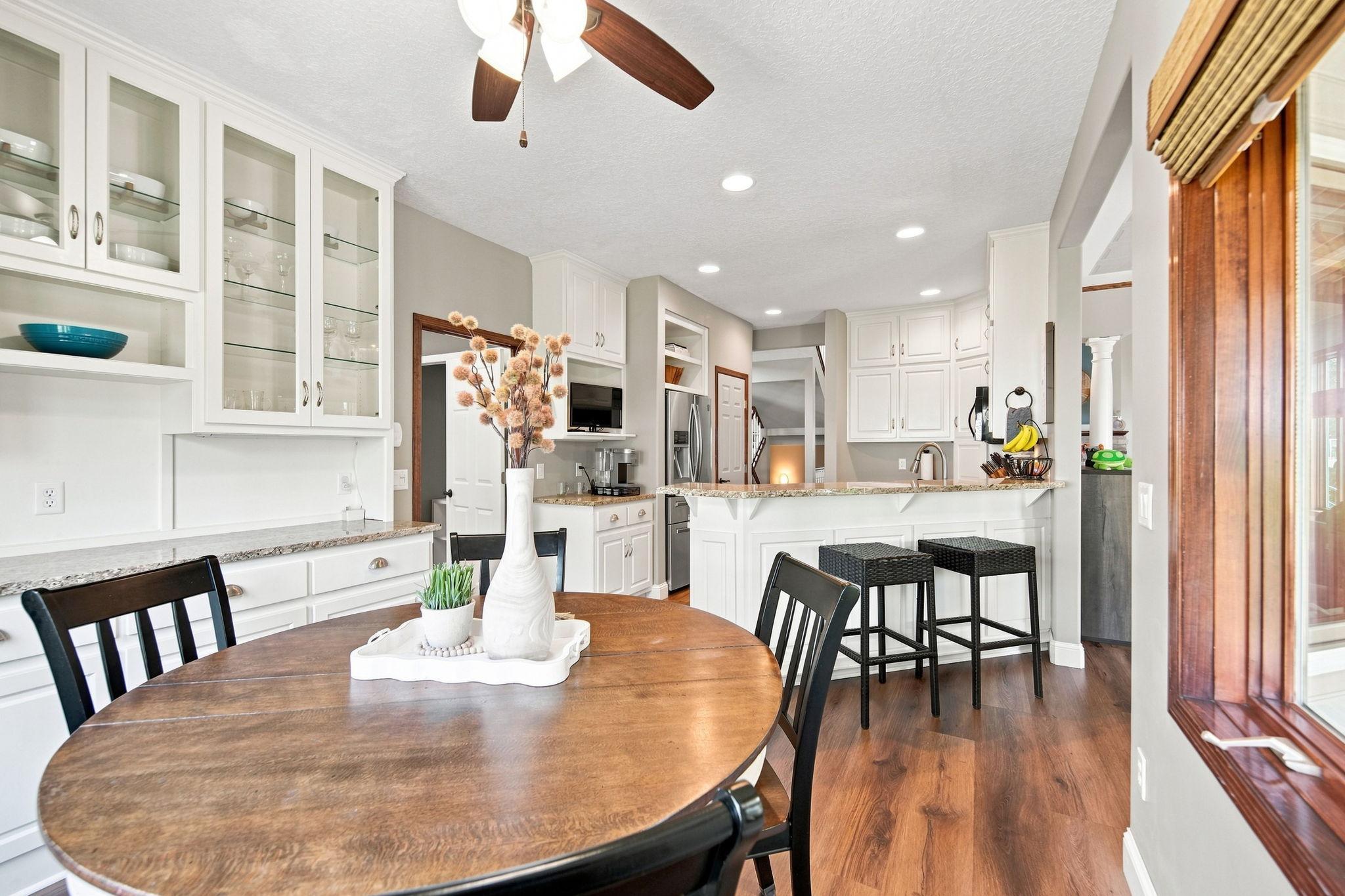 Enjoy a beautiful view into the kitchen, featuring stainless steel appliances, including a new refrigerator and dishwasher totaling over $3,000 in upgrades.