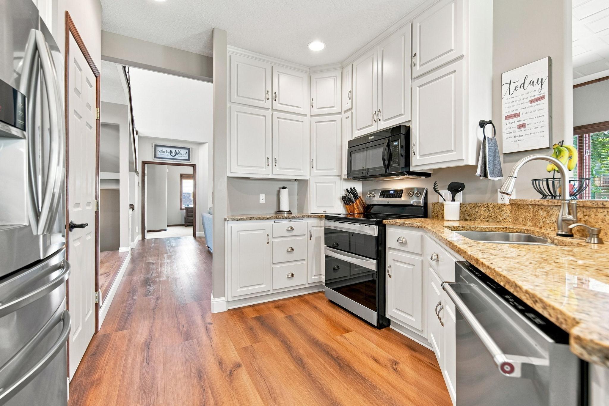 This kitchen features KitchenAid appliances, including a double oven, along with a new refrigerator and dishwasher.