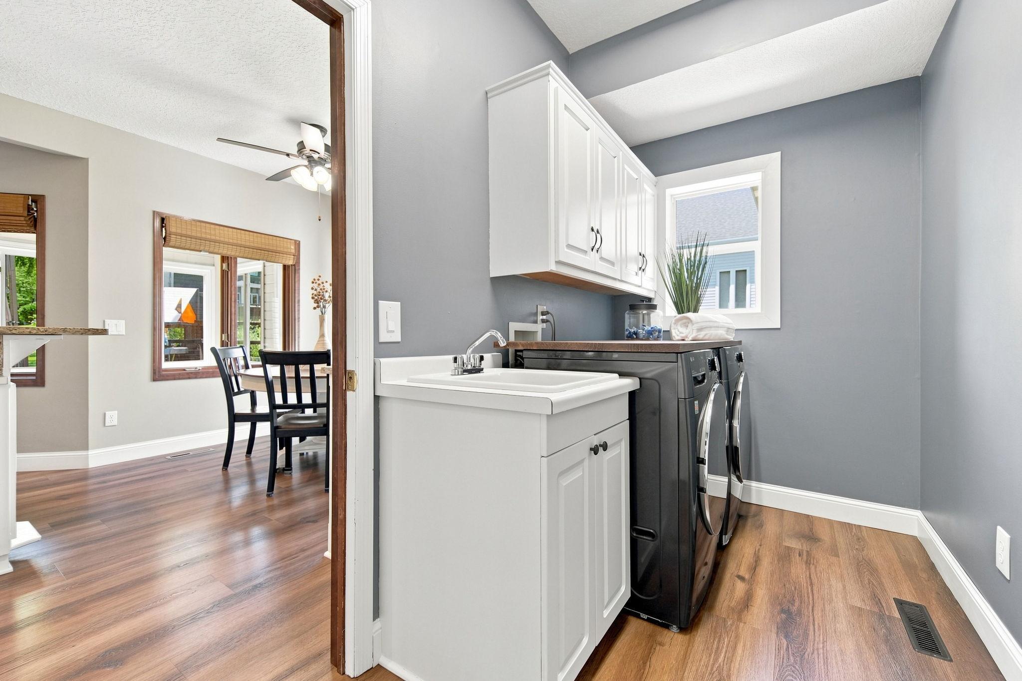Conveniently situated between the kitchen and garage, the laundry room includes high-quality front-load washer and dryer appliances, purchased new in 2021 for over $3,500.