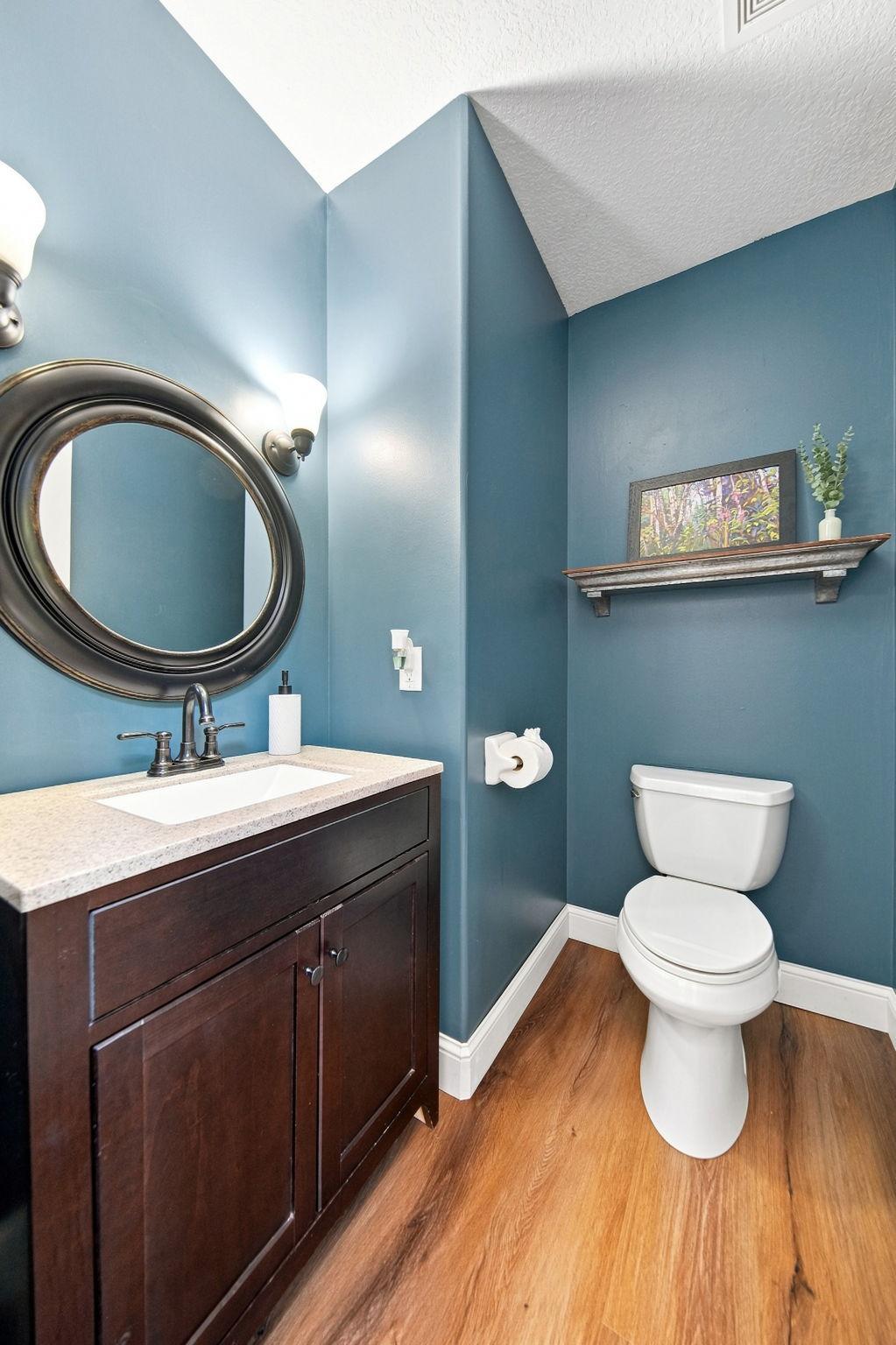 The main floor half bath has been freshly painted and offers a convenient option for guests while entertaining.