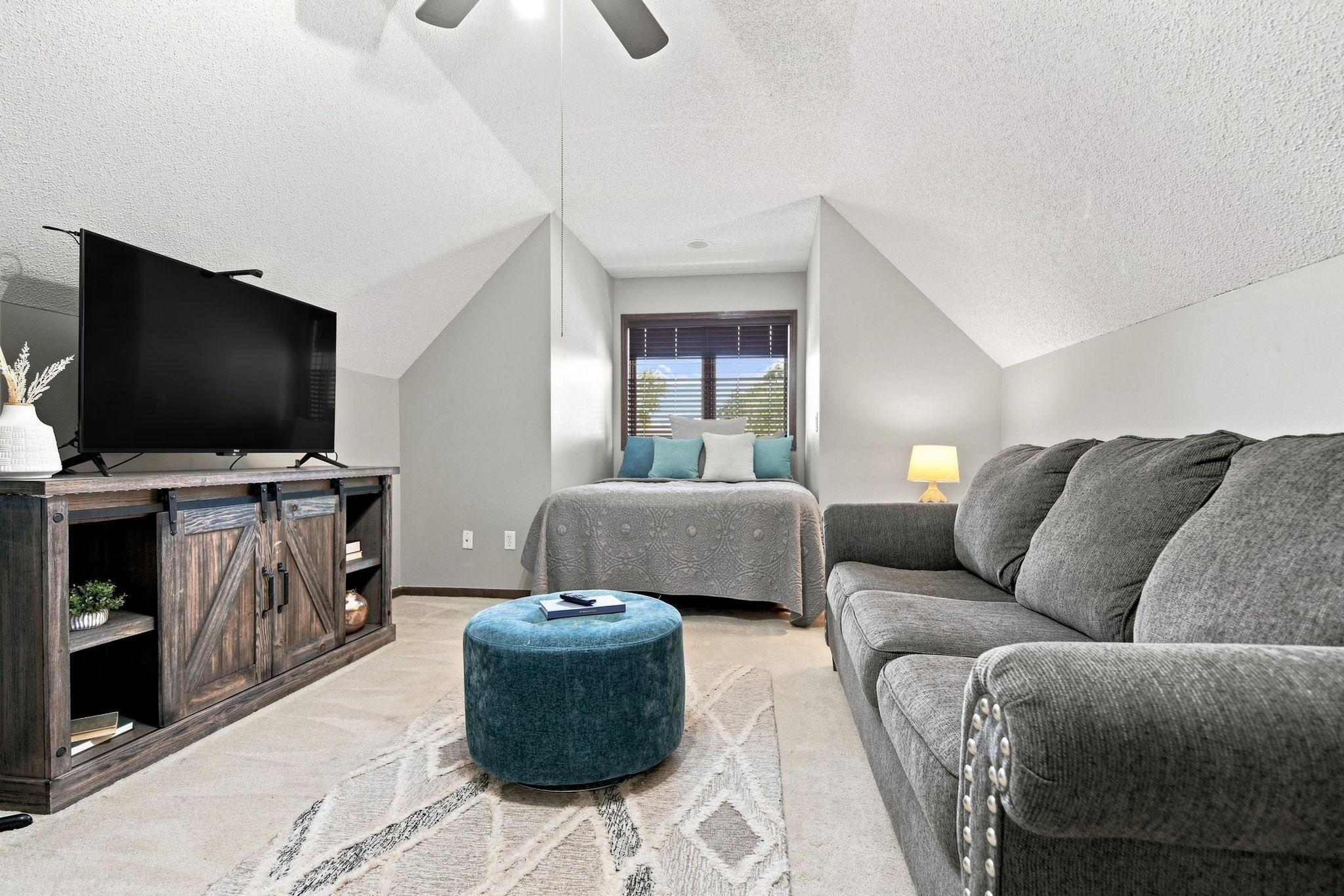 This cozy, tucked-away bedroom is one of three on the upper level and features a lovely dormer that gives the space added charm.