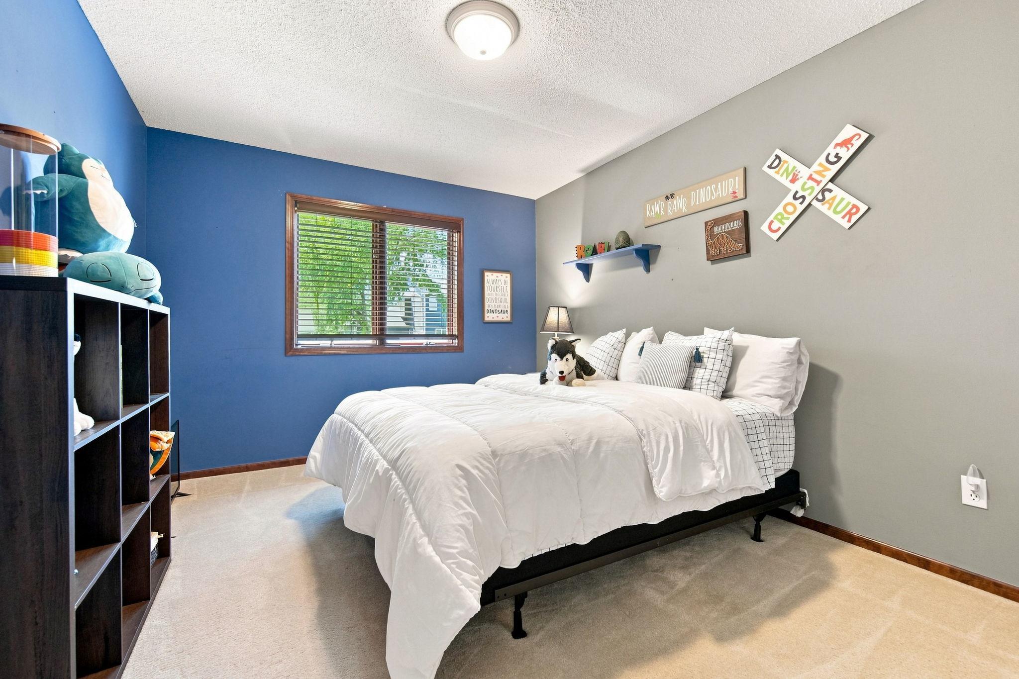 The second of three upper-level bedrooms offers a spacious walk-in closet and plenty of room.