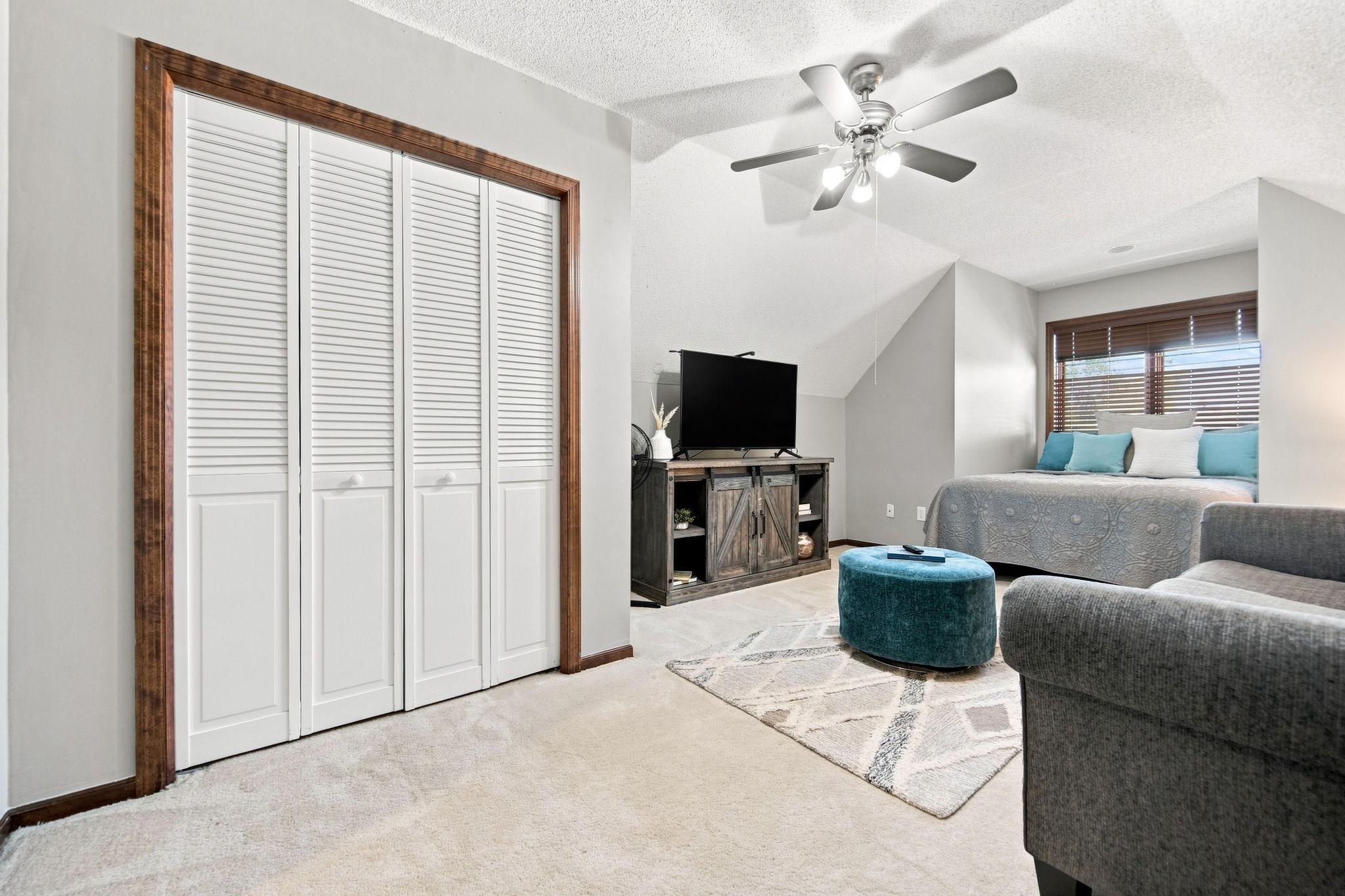 Another look at this charming bedroom, showcasing its large closet, fresh paint, and new carpeting.