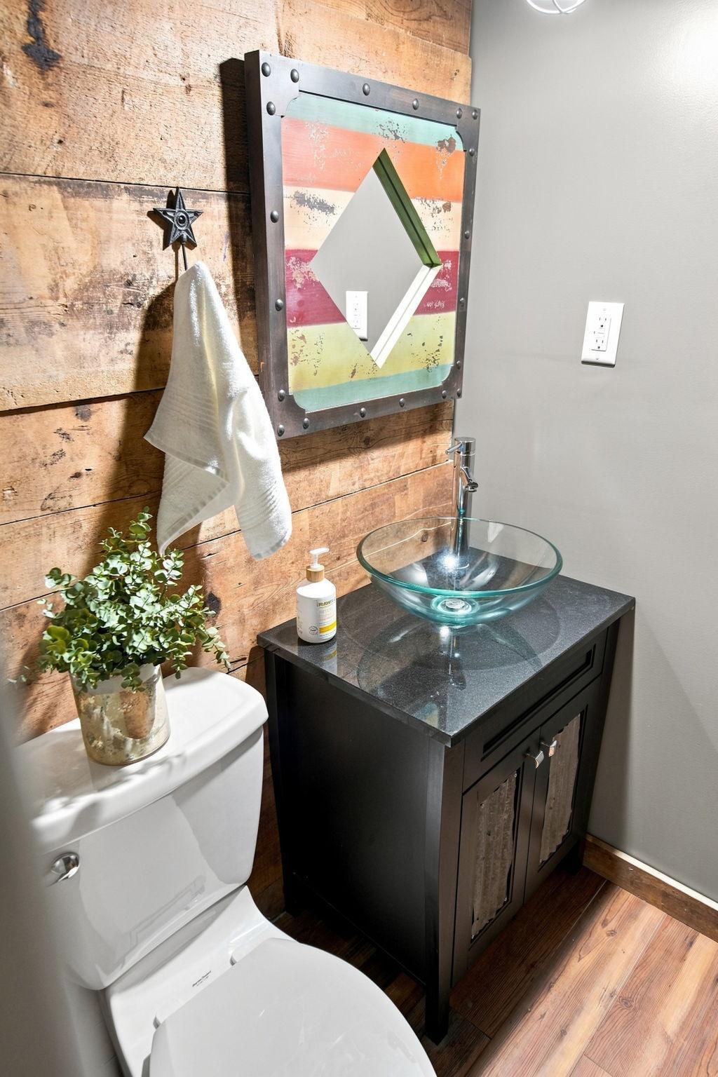 This lower-level bathroom showcases playful, creative décor and plenty of charm.