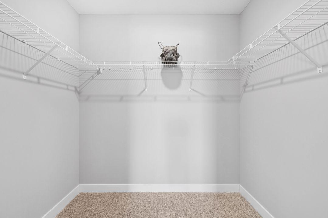 Huge walk-in closet in primary bedroom. Photo of Model home. Colors and options may vary. Ask Sales Agent for details.
