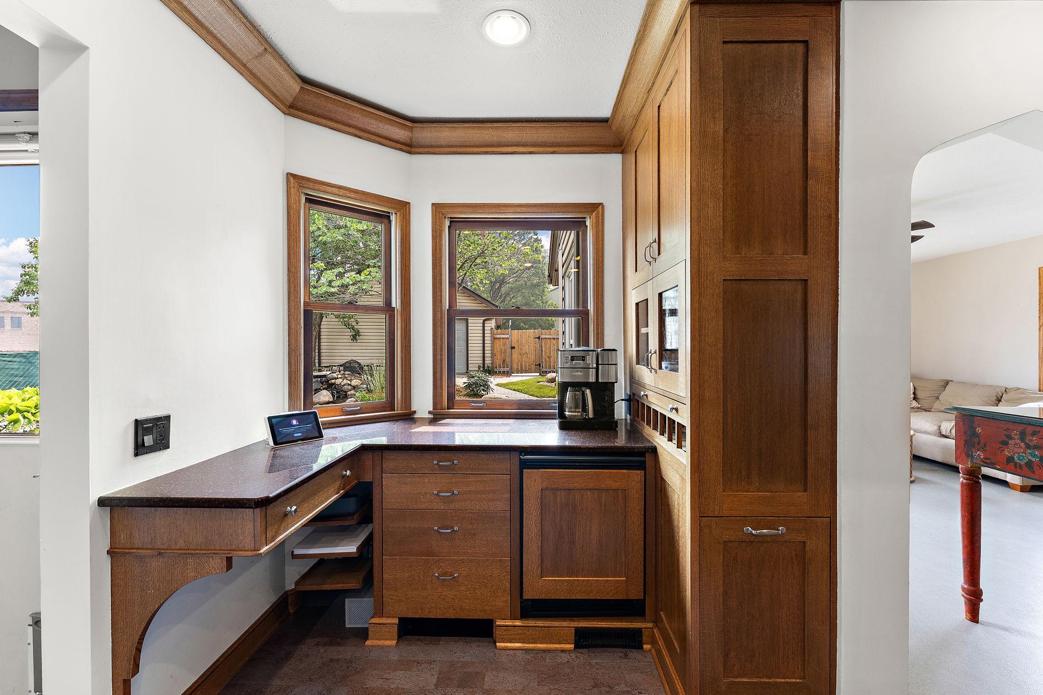 Cozy Coffee and bar nook in the kitchen with beverage fridge and hidden wine storage. See that drawer at the bottom of the right cabinet? That's your hidden trash and recycling.