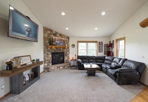 Living room with gas field stone fireplace