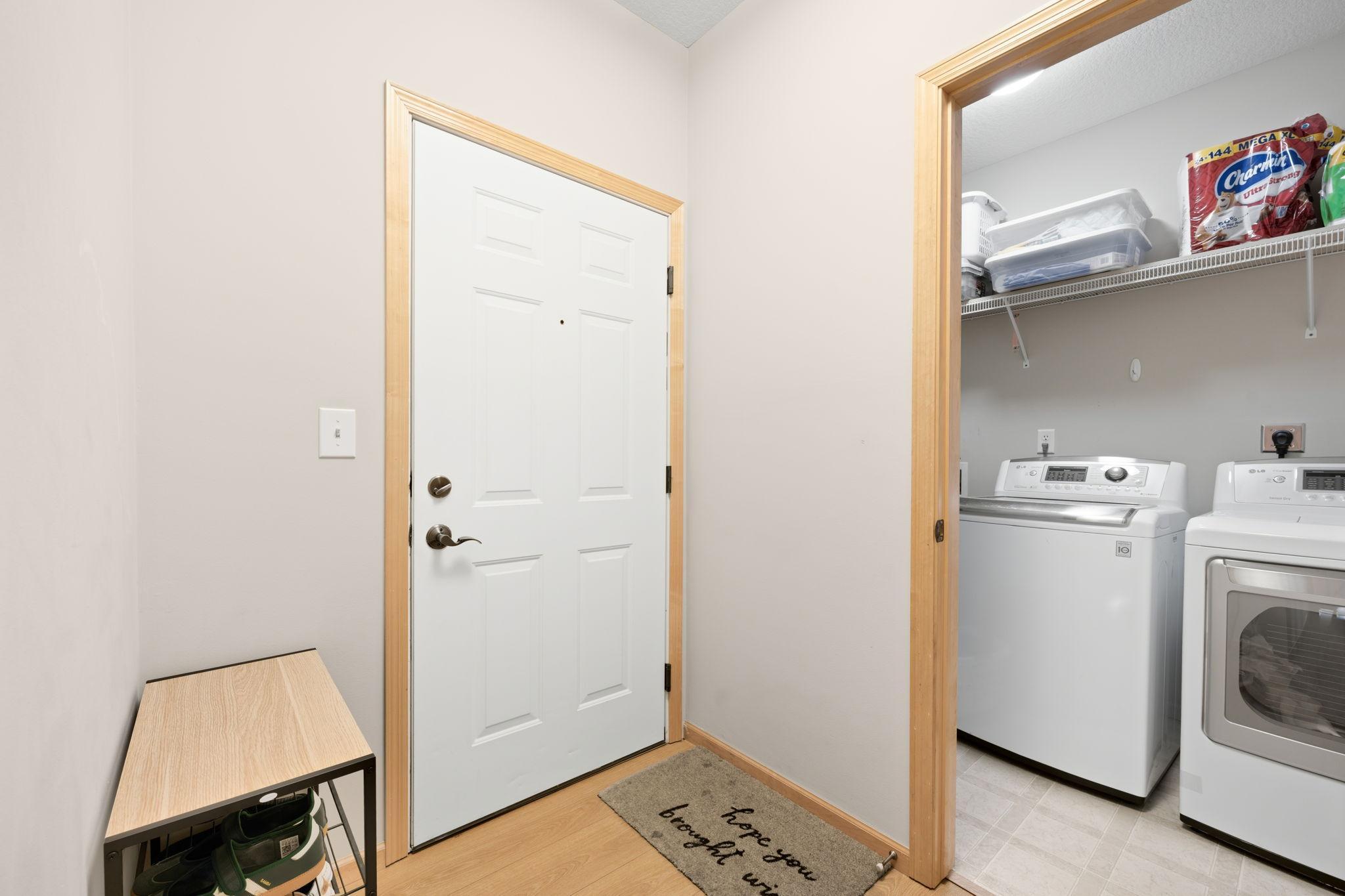Welcoming entry with durable flooring and convenient access to the spacious in-unit laundry room.