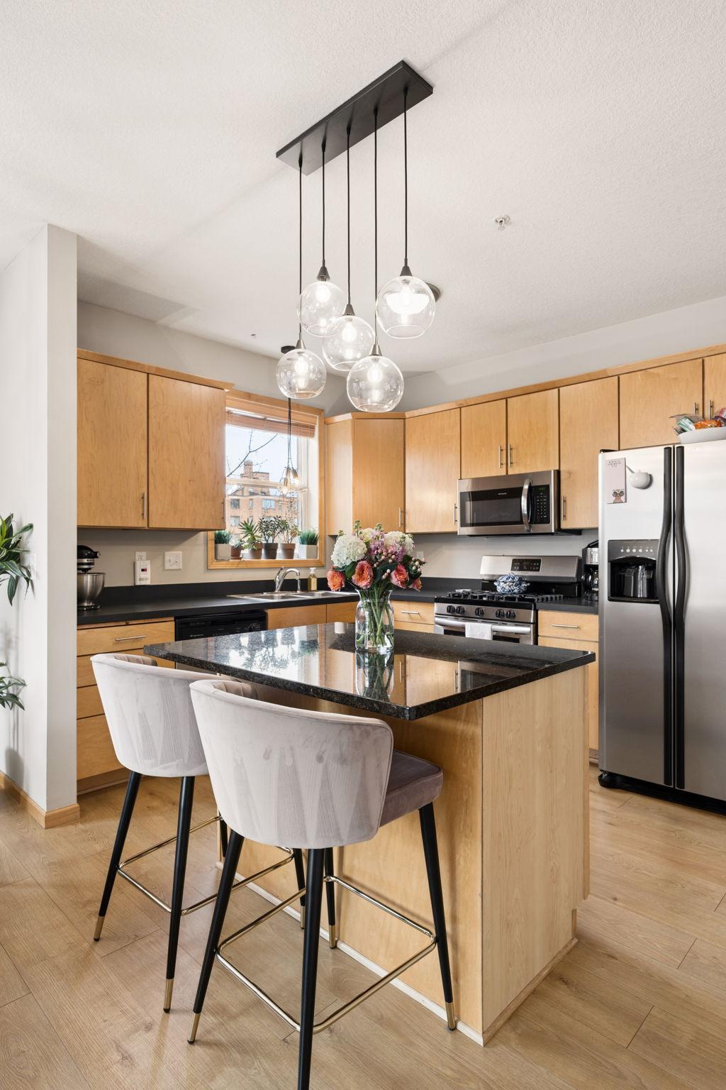 Open-concept living area with large windows, natural light, and modern finishes.