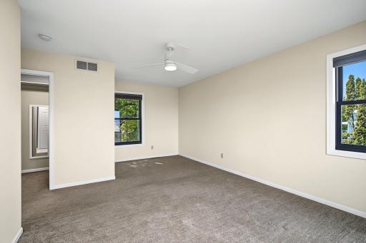 Primary bedroom with door to walk in closet