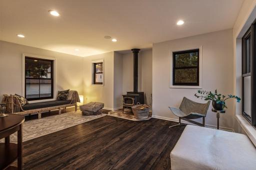 Oversided living room is flexible for furniture. Design your space around the views and the woodstove.