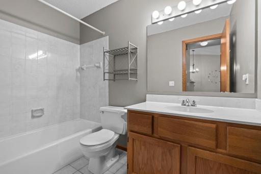 Just steps away is a full bathroom with a single vanity and tub/shower combination that has been completely regrouted and sealed (2026).