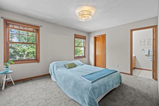 The main level features two bedrooms, both with brand-new carpeting. The spacious primary bedroom offers two front-facing windows for abundant natural light, a new ceiling fan, a 5x5 walk-in closet, and a private ensuite.