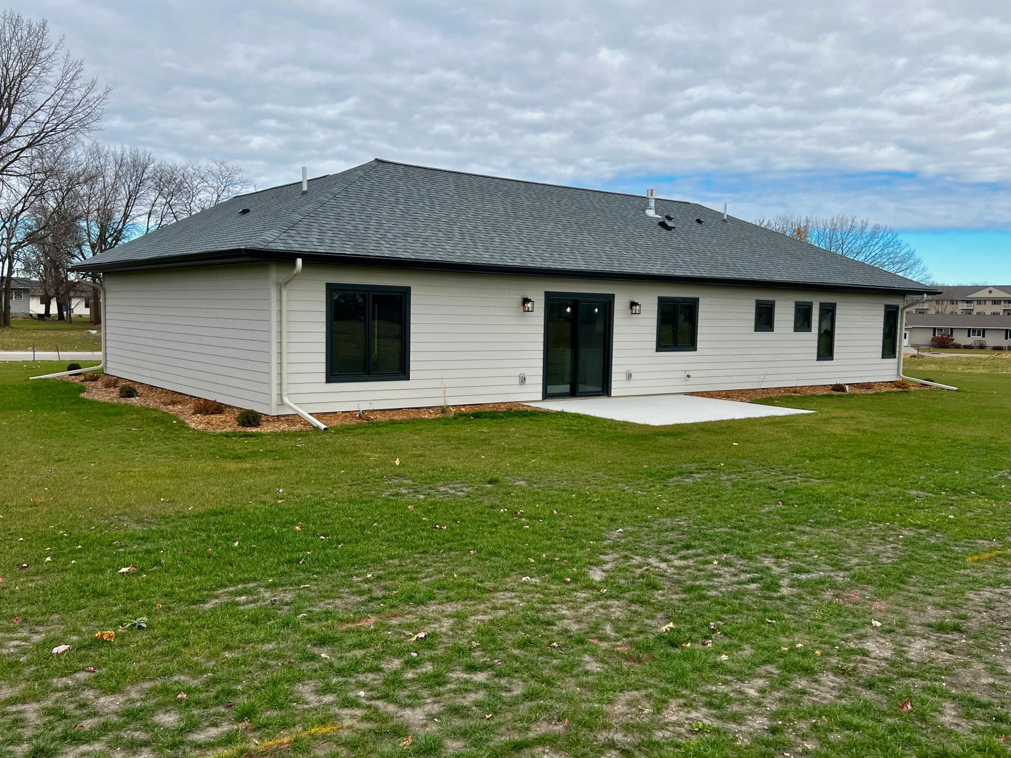 Back view of the home with Concrete Patio.