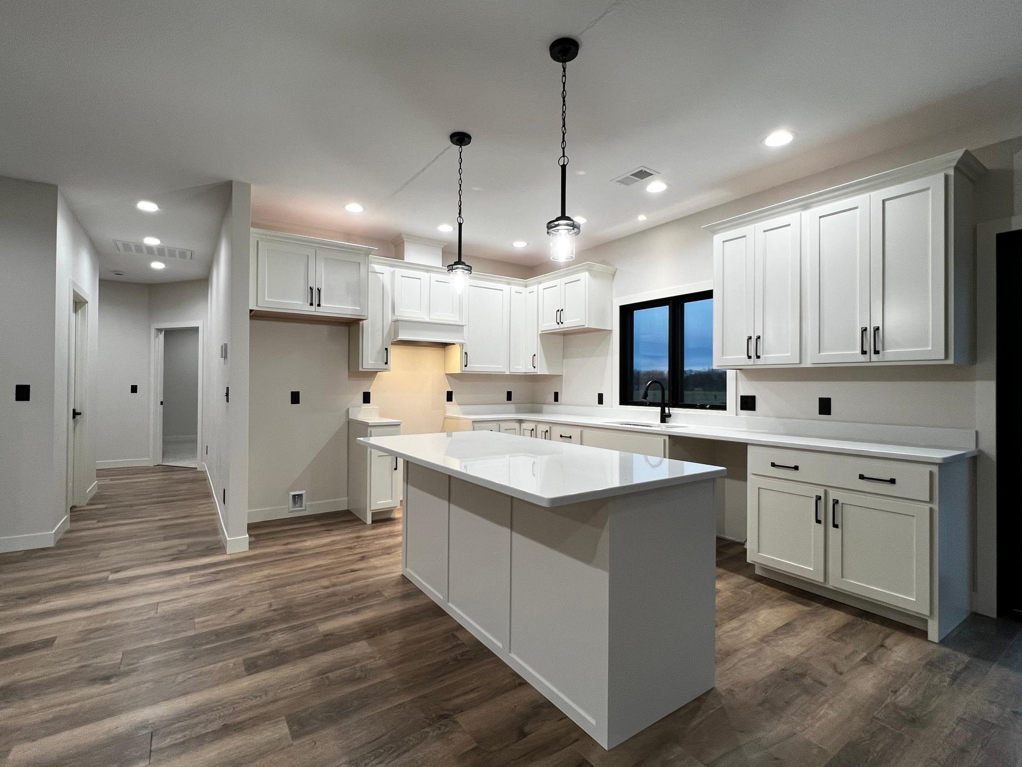 Kitchen with view of the hallway to the Pantry, Primary Bedroom and Laundry.