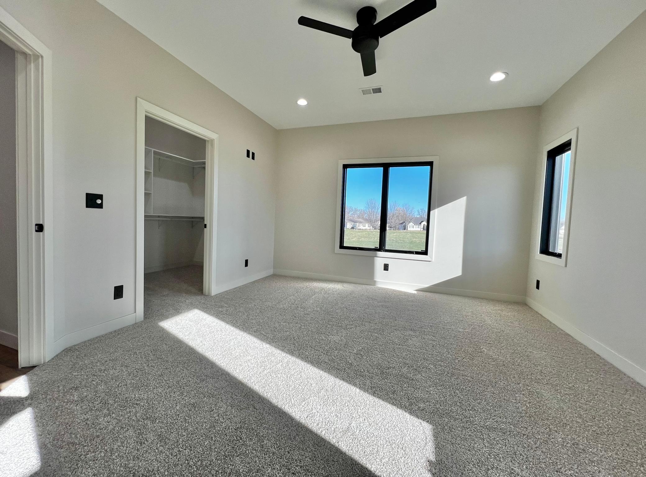 Primary Bedroom has Walk in Closet with Custom Closet Systems.