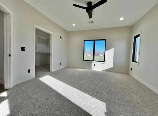 Primary Bedroom has Walk in Closet with Custom Closet Systems.