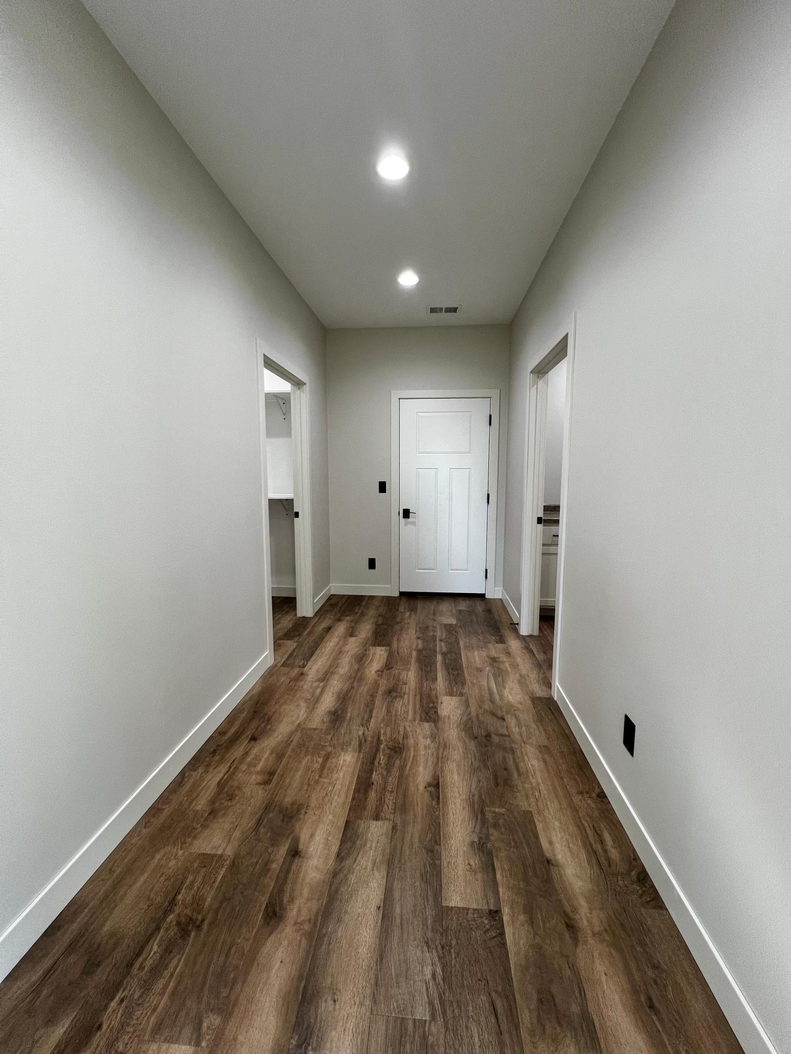 Hallway to the Laundry Room, Walk in Closet and Door to the Garage.