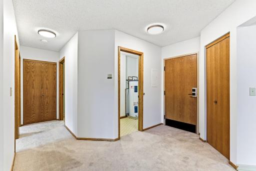 Welcoming foyer and plentiful storage in utility room, the entryway coat closet, AND additional private storage room just down the hall!